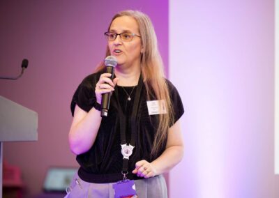 Abigail Hawkins FCCT (The SENsible SENCO) on stage with the microphone at SENsible24 SENCO Conference.