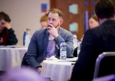 A SENCO looking out quizatively at a table in the conference.