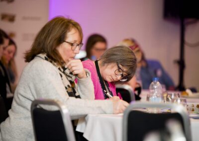 Two SENCOs sitting at a table taking notes at the SENsible24 SENCO Conference