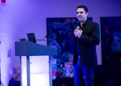 Gavin Hawkins opening up the SENsible24 SENCO Conference, wearing a suit and using a microphone.