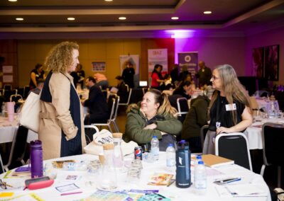 Abigial Hawkins talking to two SENCOs around a table at the SENsible24 SENCO Conference